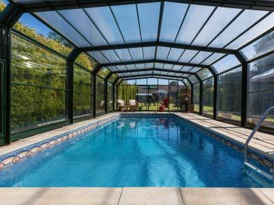 A swimming pool in the garden of a large country property in England.