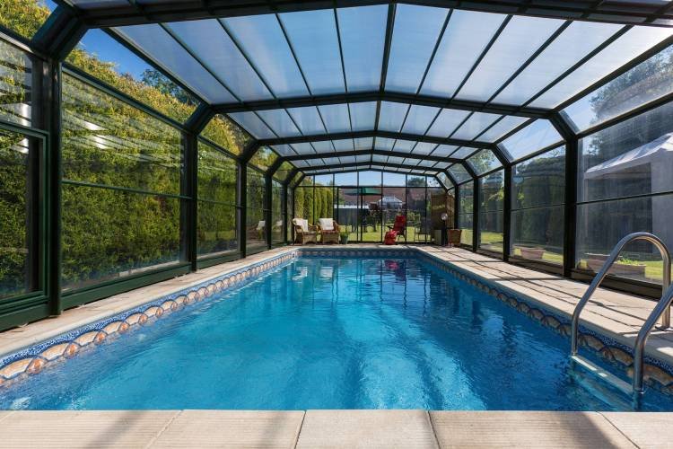 A swimming pool in the garden of a large country property in England.